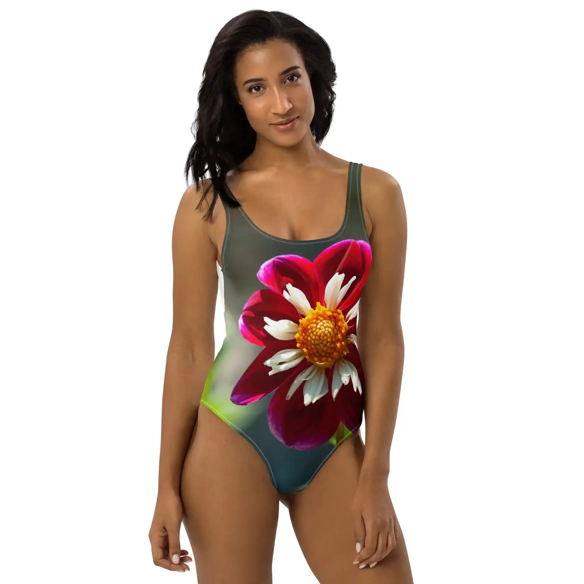 A women's one-piece swimsuit featuring the 'Crimson Crown' photograph by Bill Fowle. The design displays a large, vibrant red poppy flower with a detailed dark center and delicate petals across the front of the suit.