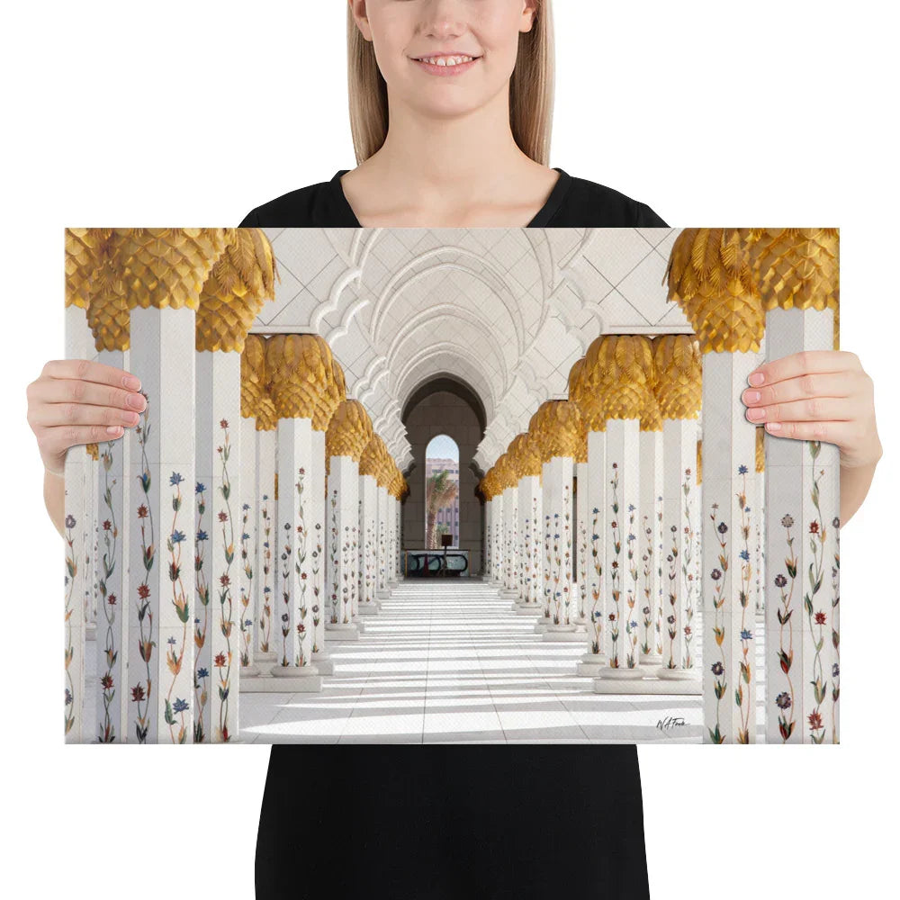 Woman holding premium canvas print featuring ornate white and gold marble columns, professional photography home decor from Bill's Photo Shop.