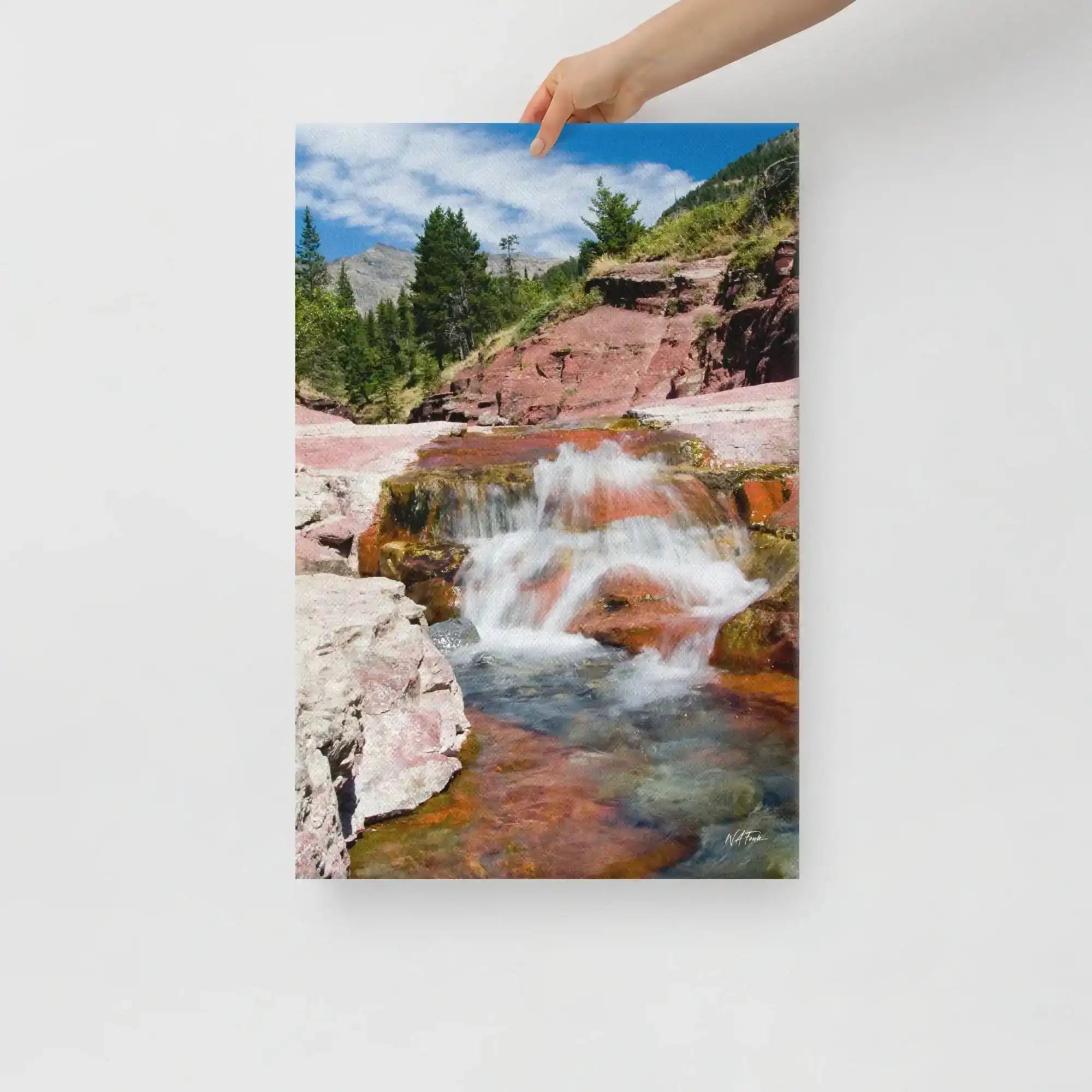 Hand holding canvas print of waterfall and rocky landscape, Bill's Photo Shop wall art