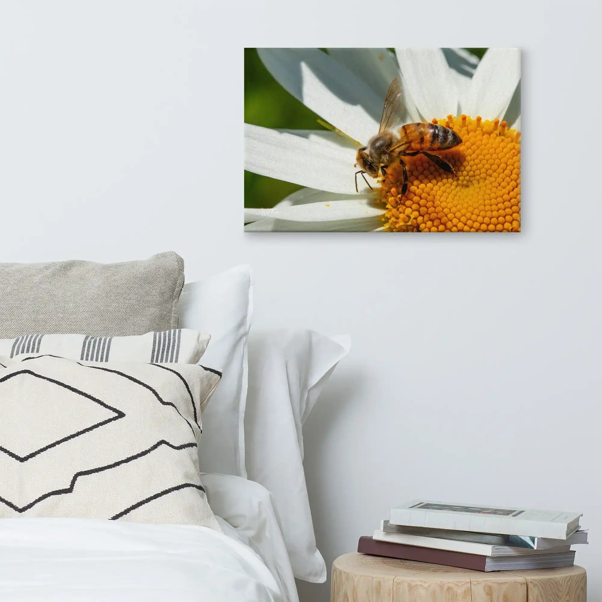 Bee on daisy flower canvas wall art above modern bed with decorative pillows