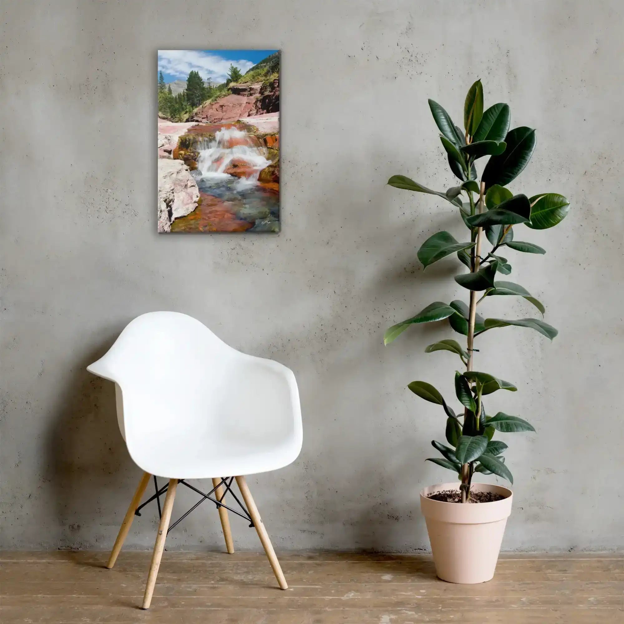 Modern room with white chair, potted plant, and wall art of a waterfall landscape from Bill's Photo Shop