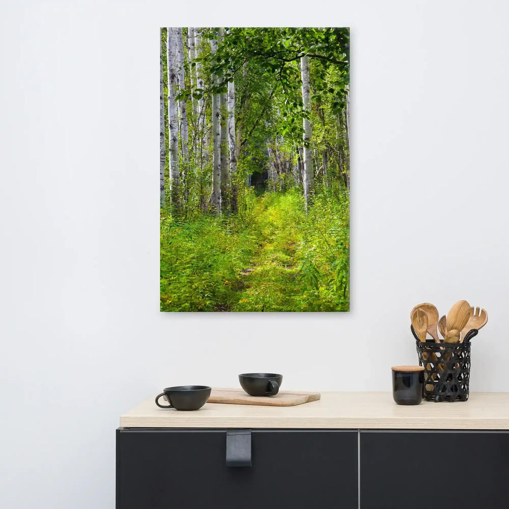 Canvas wall art featuring a lush green forest path with tall birch trees in a modern kitchen