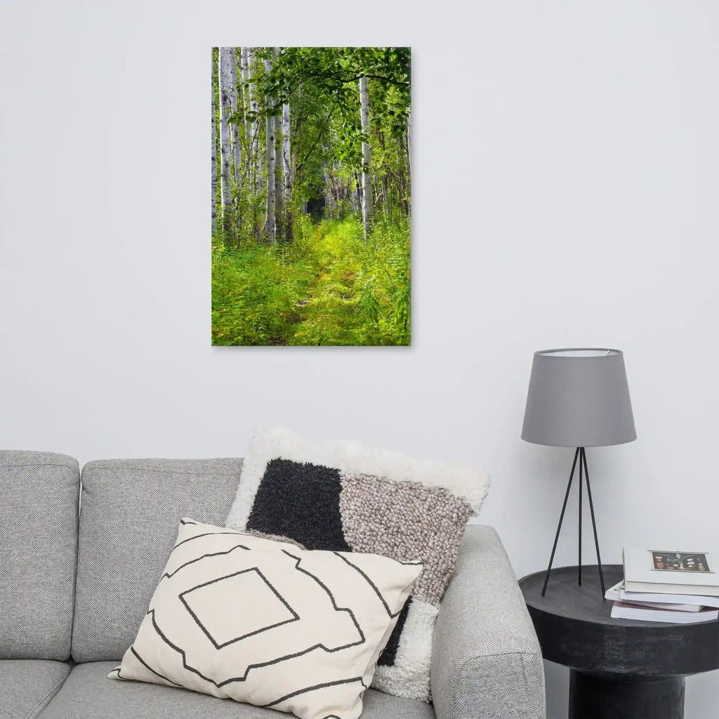 Canvas wall art featuring a vibrant forest path scene, displayed in a modern living room