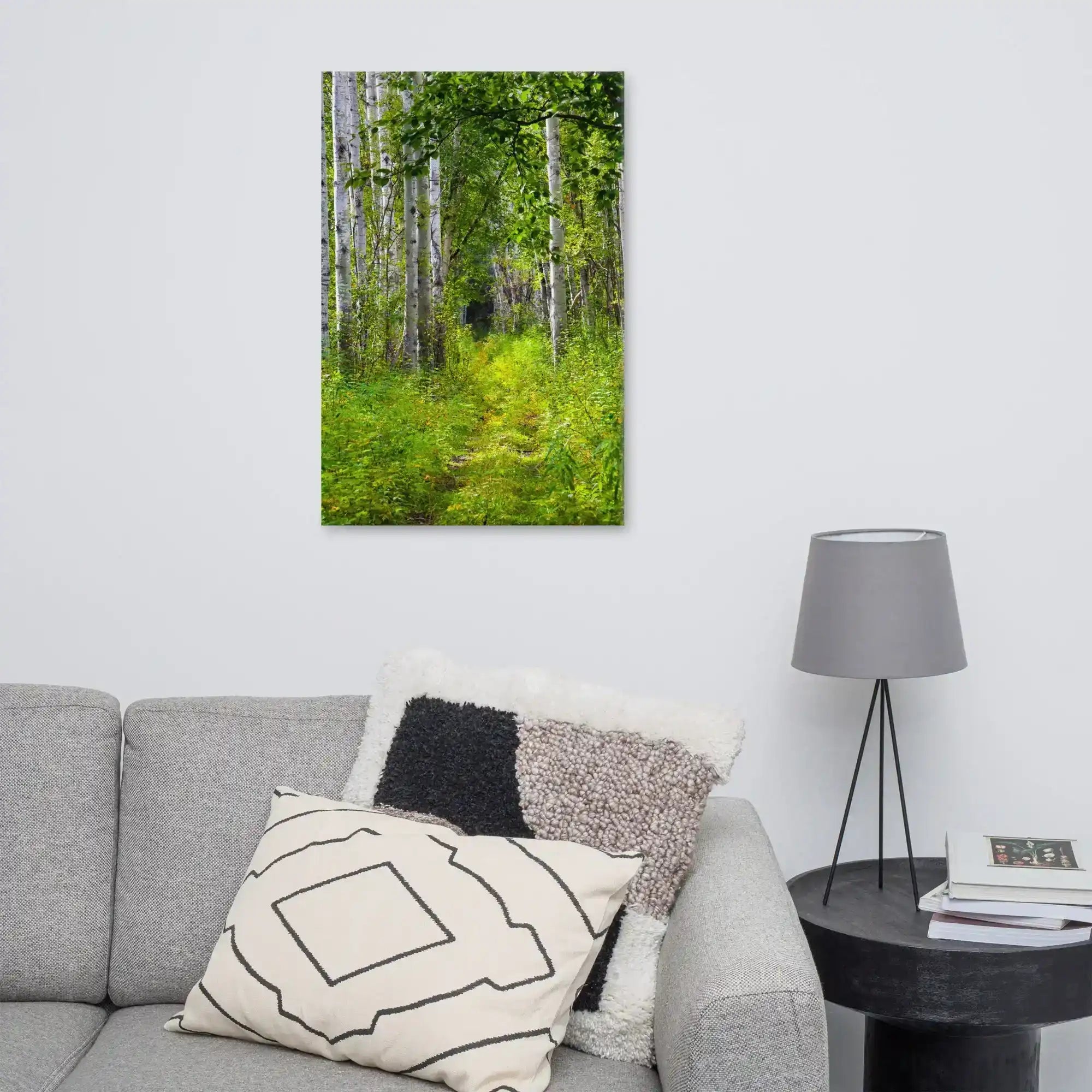 Canvas wall art featuring a vibrant forest path scene, displayed in a modern living room