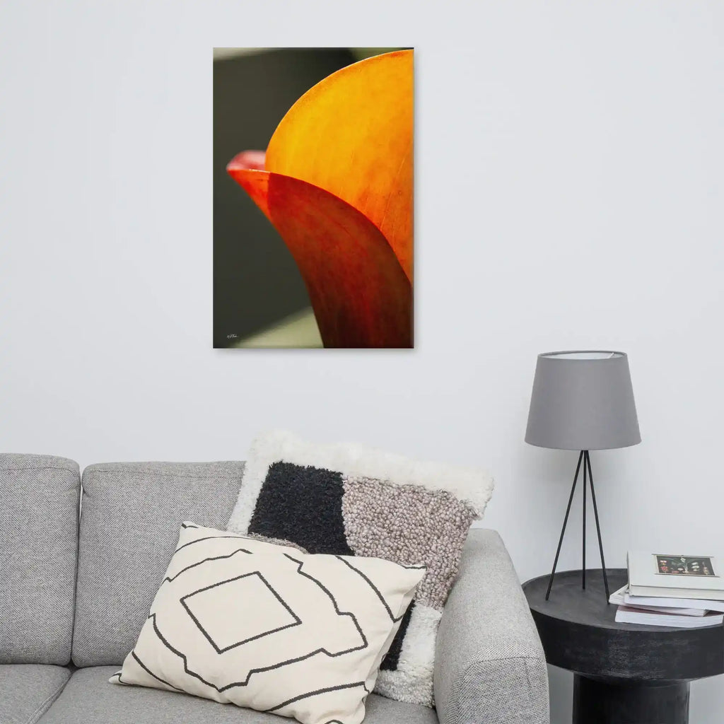 A vertical fine art macro photograph of a Calla Lily petal in shades of vibrant orange and gold. The sunlight filters through the petal, highlighting fine veins and textures against a soft, dark background. The image is presented as a professional gallery-wrapped canvas by Bill Fowle.