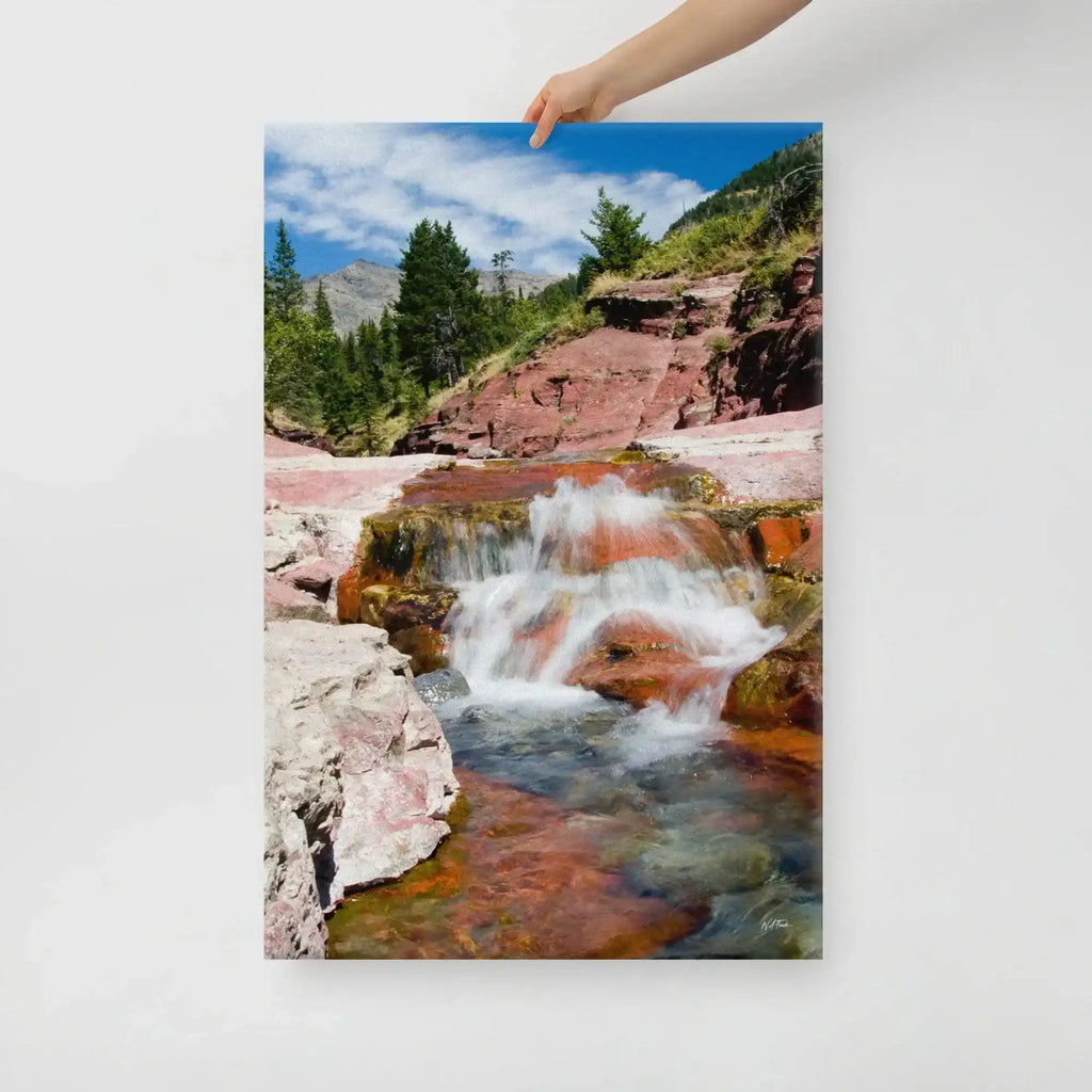 Hand holding canvas print of waterfall scene with red rocks and pine trees, Bill's Photo Shop decor