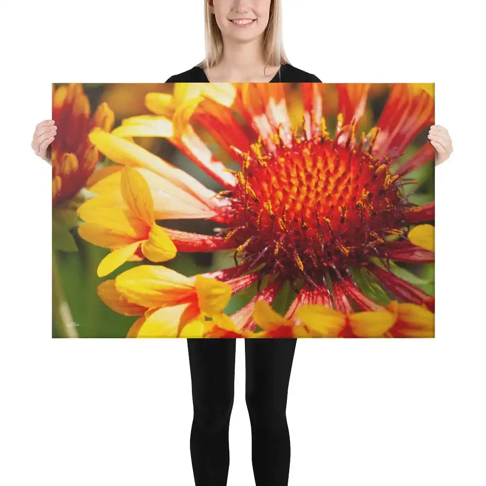 Woman holding large canvas print featuring vibrant close-up of red and yellow flower