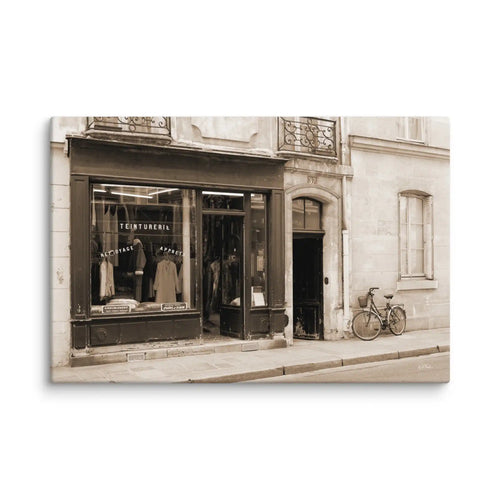 Vintage-style photograph of a store front with a bicycle on a white brick wall background