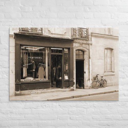 Vintage-style photograph of a store front with a bicycle on a white brick wall background