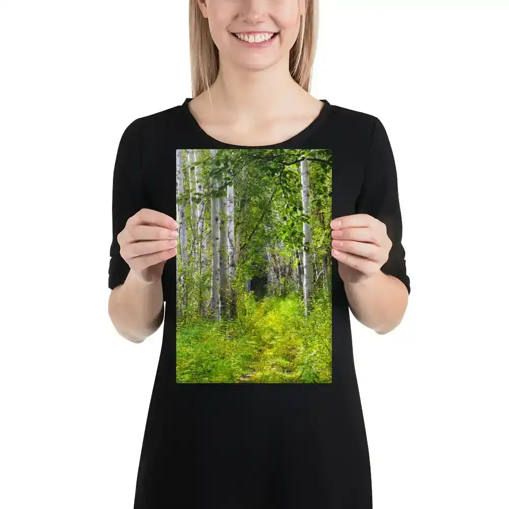 Woman holding 8x12 canvas print with vibrant forest path and green trees, nature wall art