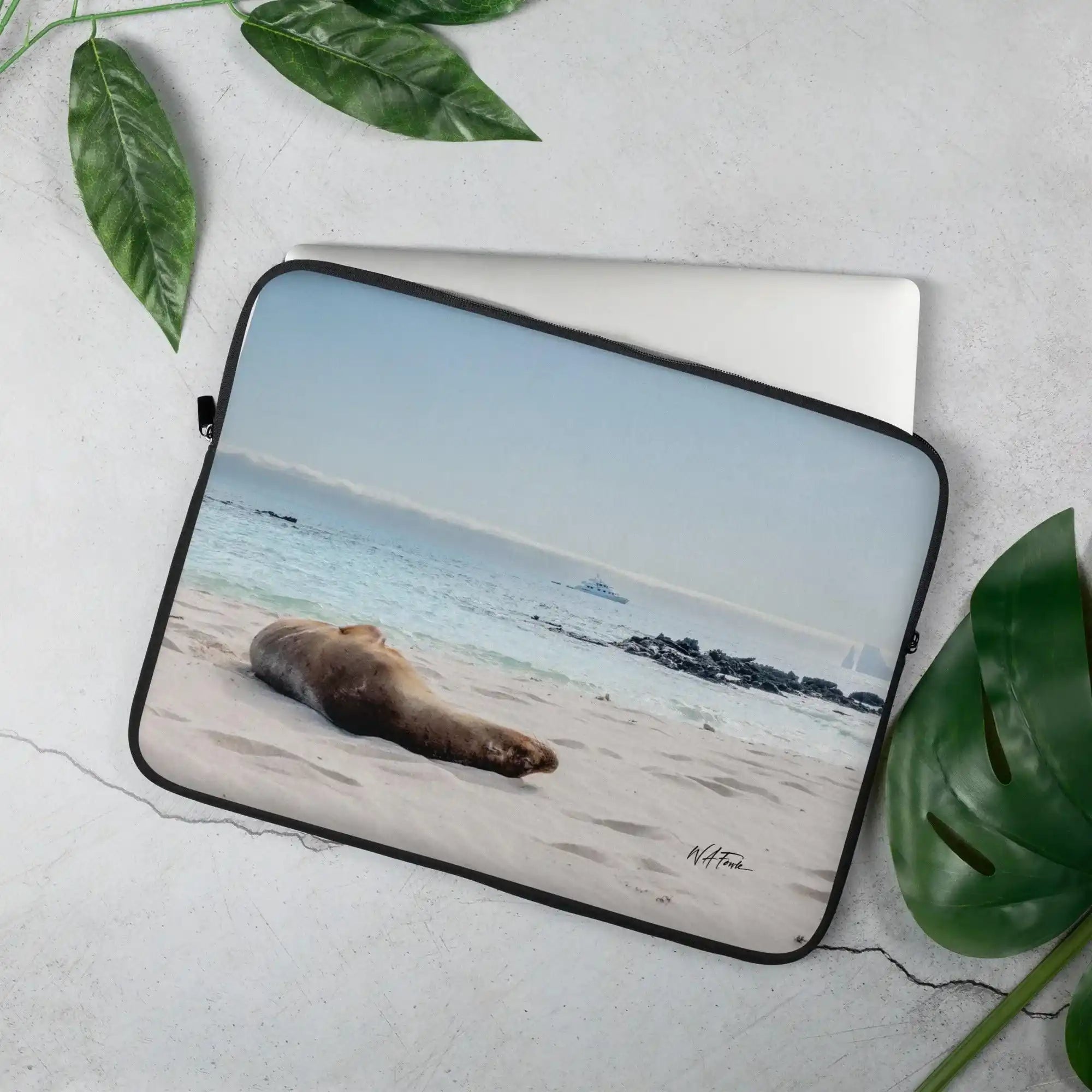 Laptop sleeve with beach sea lion photo print, decorative leaves, and Bill's Photo Shop branding