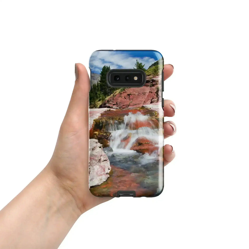 Hand holding Samsung Galaxy S10e case with glossy waterfall and rocky landscape print