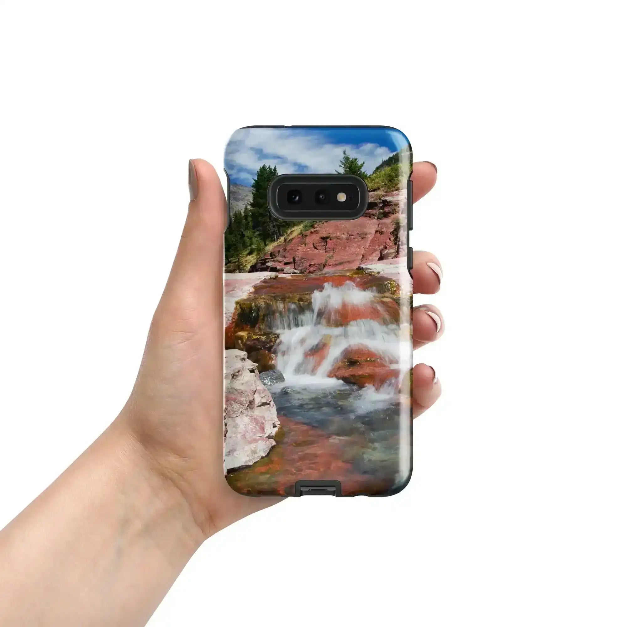 Hand holding Samsung Galaxy S10e case with glossy waterfall and rocky landscape print