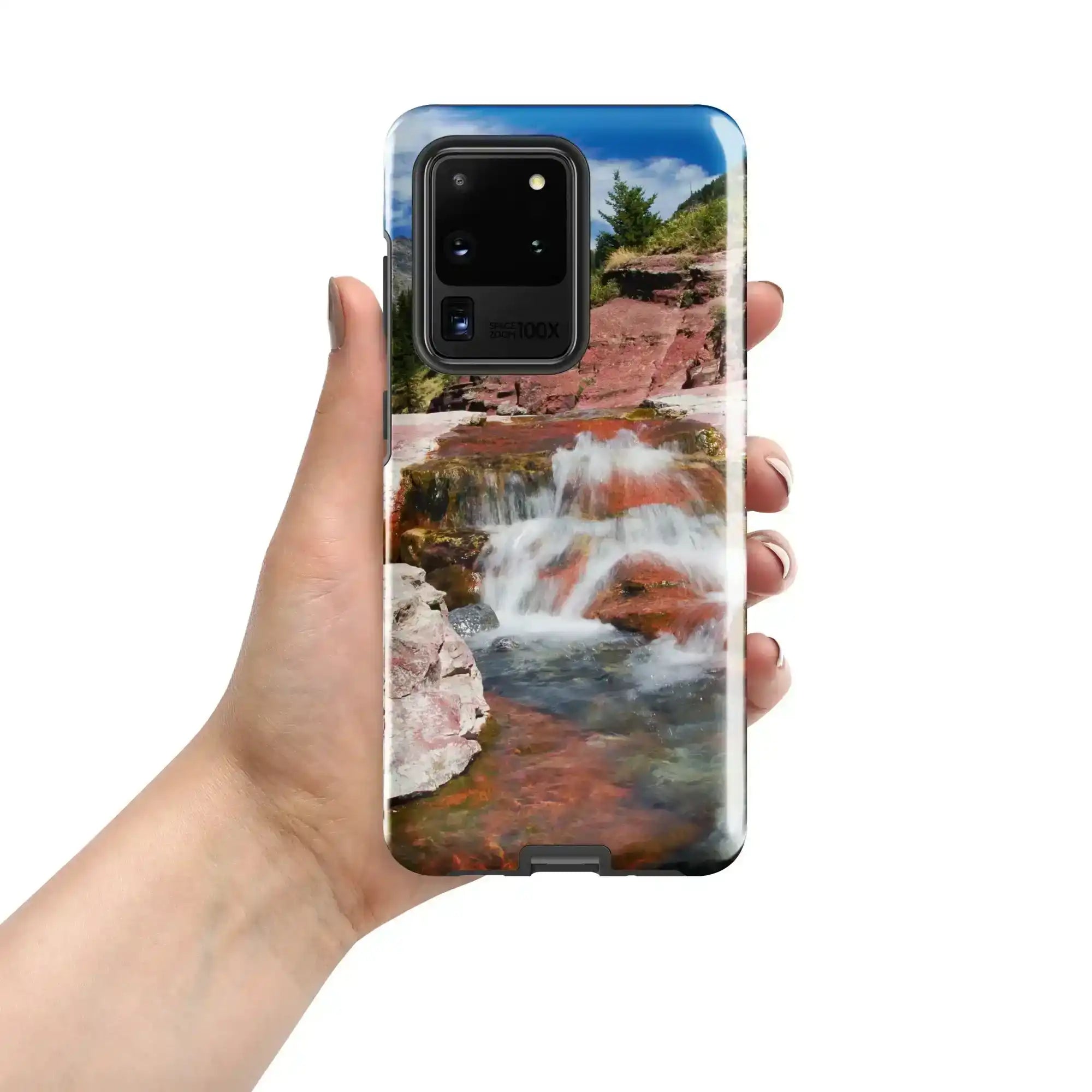 Hand holding Samsung Galaxy S20 Ultra case with scenic waterfall and rocky landscape design