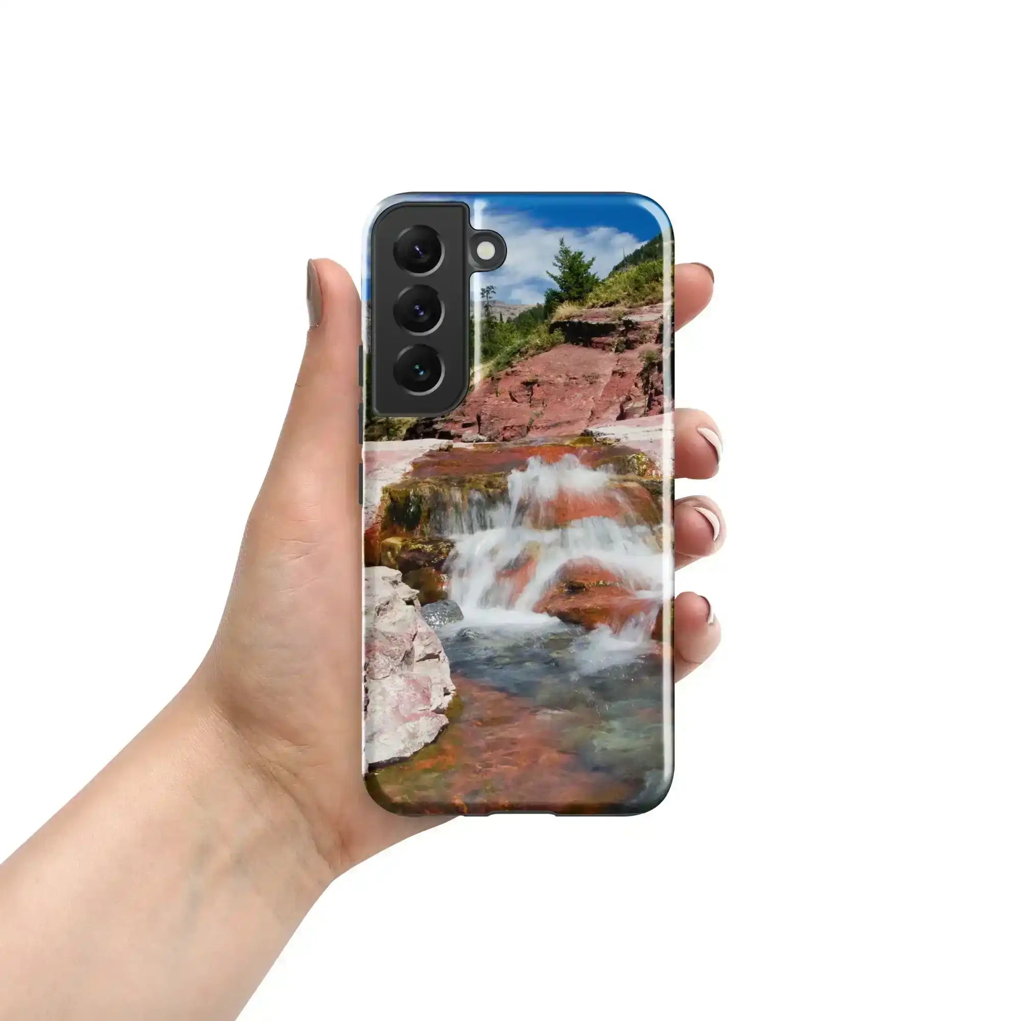 Hand holding Samsung Galaxy S22 case with vibrant waterfall and rocky landscape design