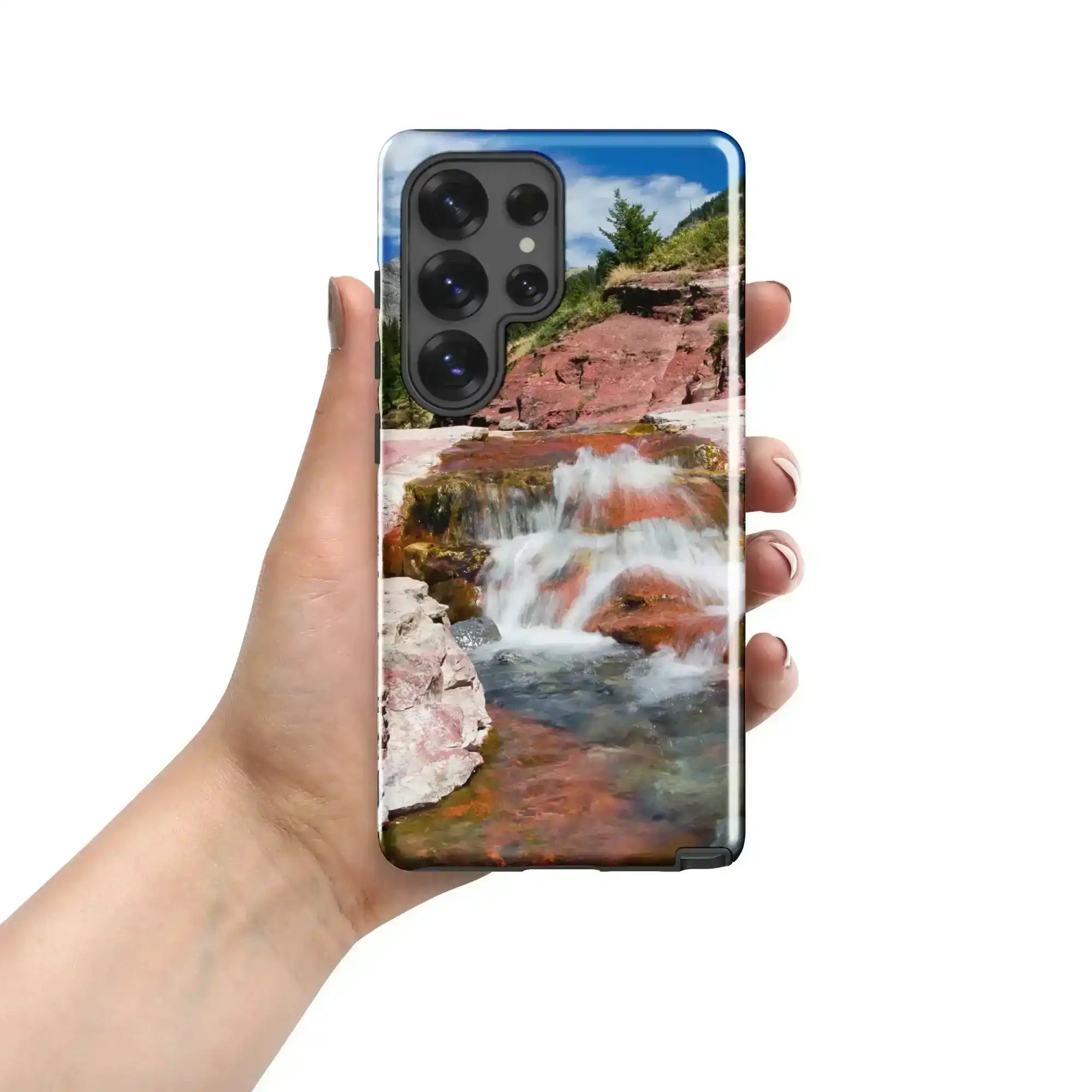 Hand holding Samsung Galaxy S25 Ultra case with glossy waterfall landscape design