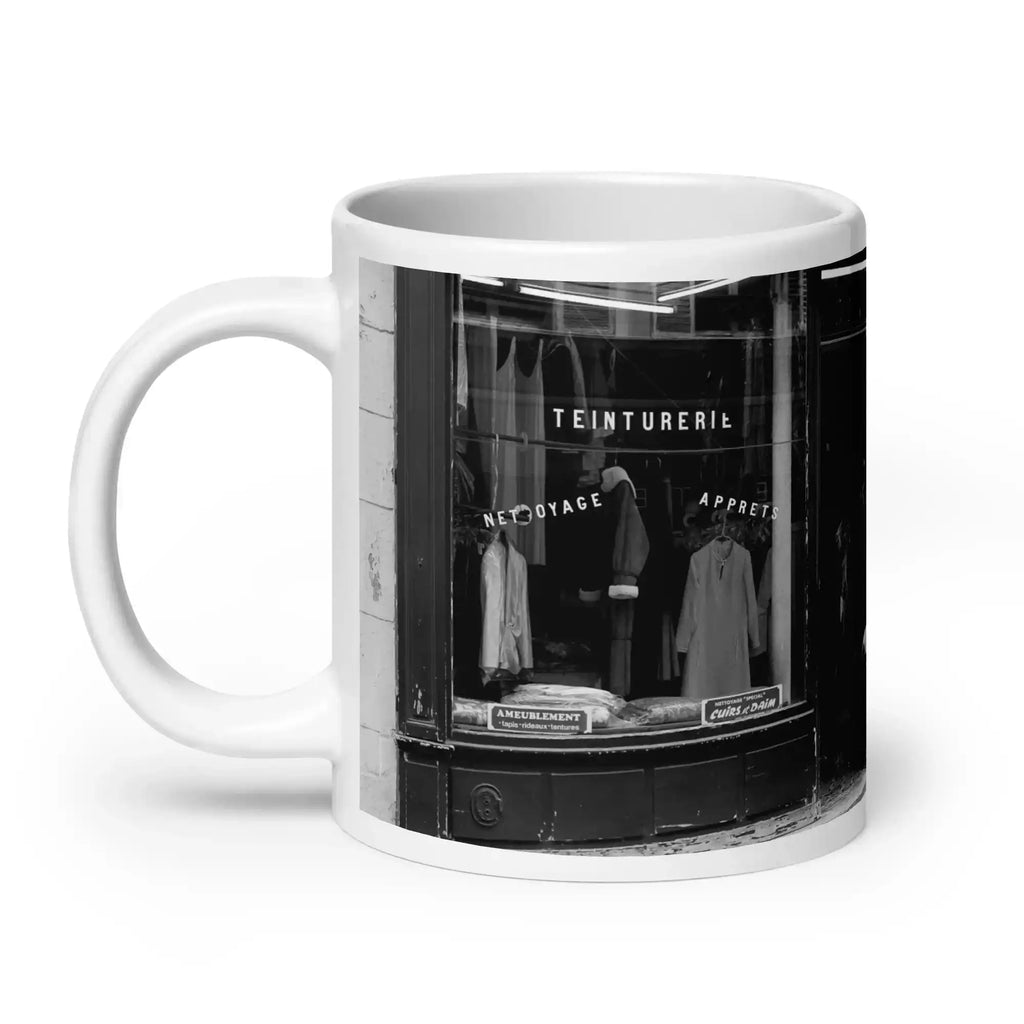 White glossy ceramic mug featuring vintage black-and-white photo of a storefront window.