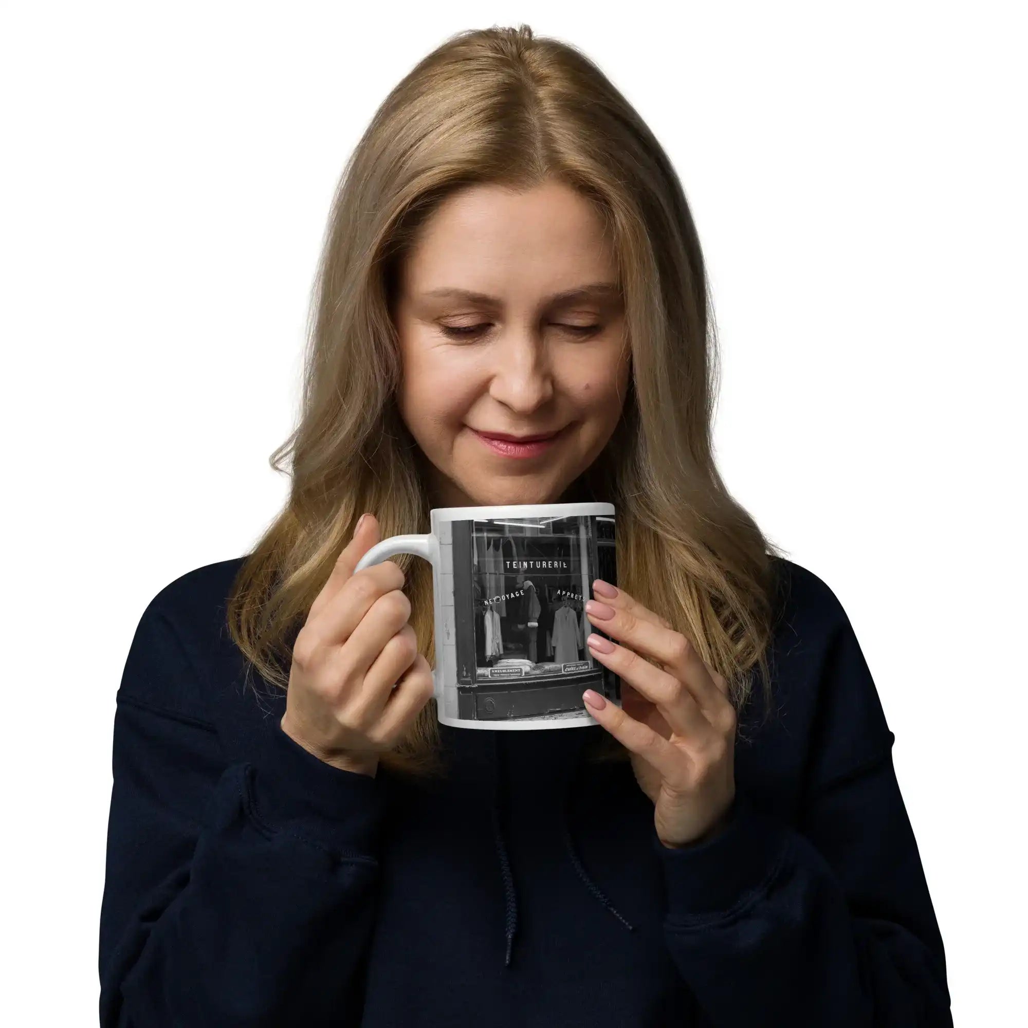 Woman holding a white glossy photo mug with a black and white storefront image, isolated background